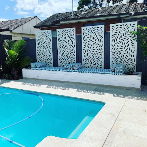 Bench with patterned blue seat cushions beside a swimming pool