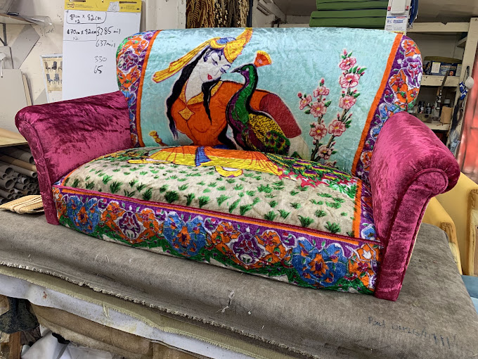 Sofa with magenta arms and multicoloured illustrated upholstery